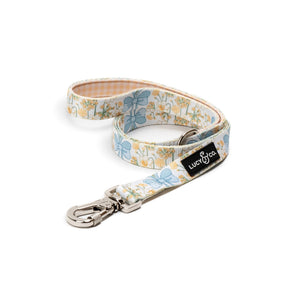 Lucy & Co. Sunshine and Daffodils dog leash with yellow floral print, blue bows, and a secure lockable carabiner.