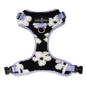 Lucy & Co. Far Out fleece no-pull dog harness in a black and white cow print with lavender trim and metal hardware.