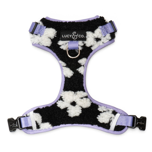 Lucy & Co. Far Out fleece no-pull dog harness in a black and white cow print with lavender trim and metal hardware.