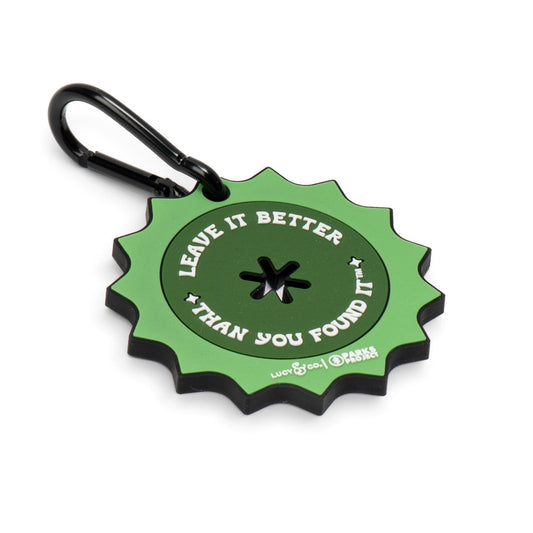 Lucy & Co. x Parks Project green rubber poop bag clip with a black metal carabiner and Leave it Better text design.