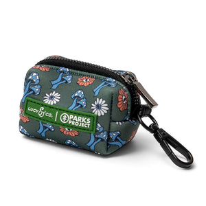Lucy & Co. x Parks Project poop bag holder in green with a mushroom and flower print, featuring a black leash clip.