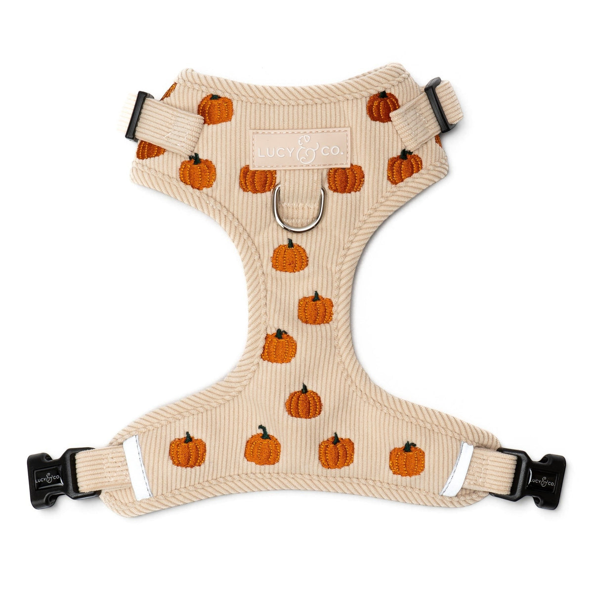 Lucy & Co. beige corduroy dog harness featuring an embroidered pumpkin pattern and front leash attachment point.